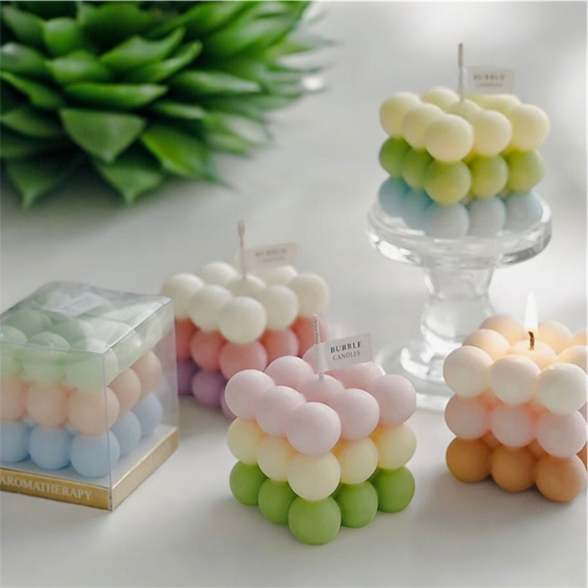 Assorted pastel bubble cube scented candles in pink, green, blue, yellow and tan