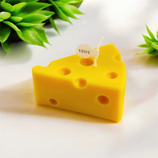 Single yellow Swiss cheese wedge shaped scented candle