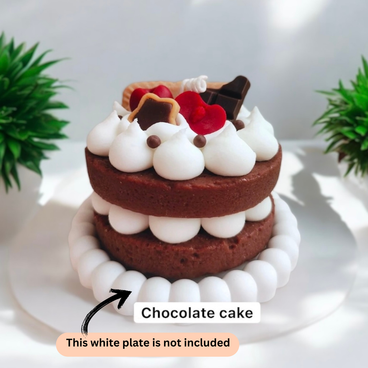 Dark chocolate two layer cake scented candle with cream swirls and a chocolate bar