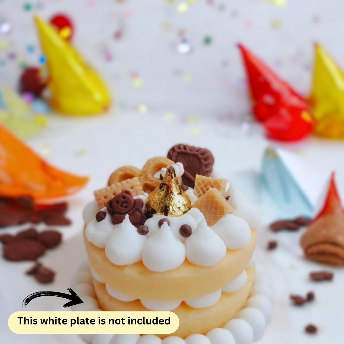 Light brown two layer cookie cake scented candle with party hats and confetti