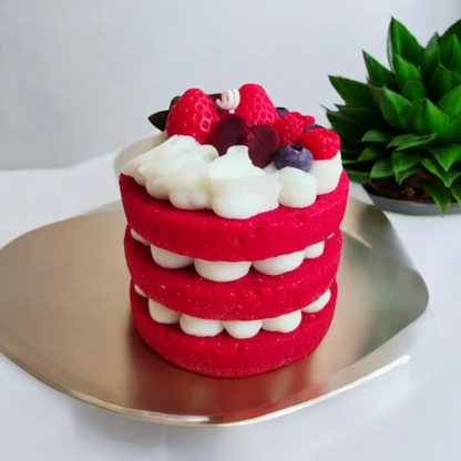 Red velvet three layer cake scented candle topped with strawberries and berries