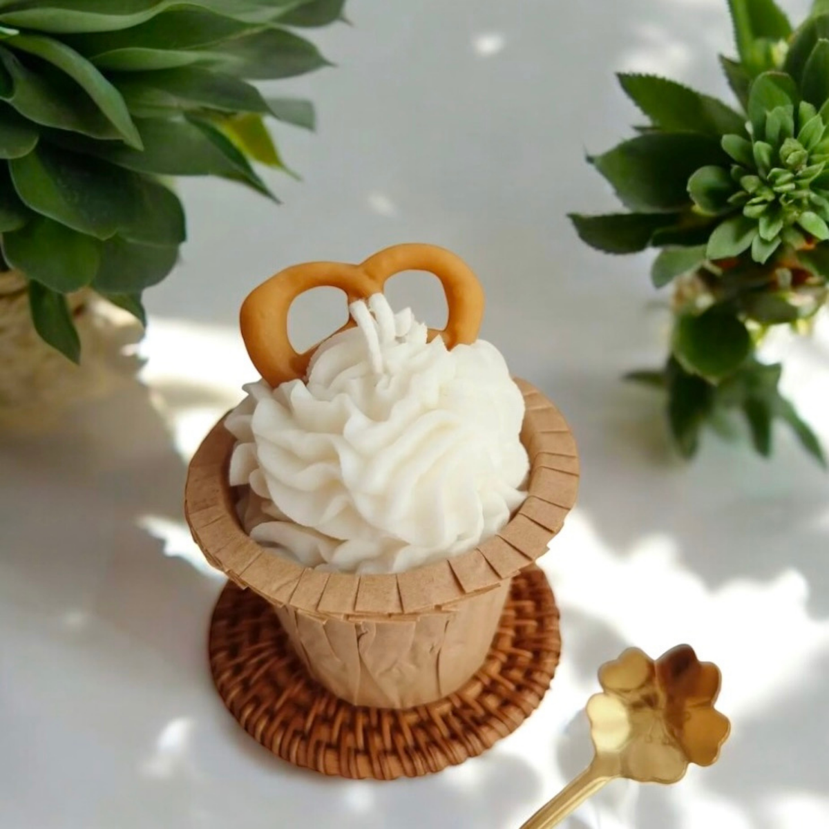 Vanilla swirl cupcake scented candle topped with a pretzel