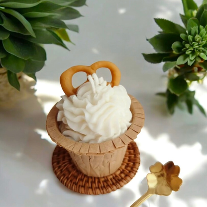 Vanilla swirl cupcake scented candle topped with a pretzel