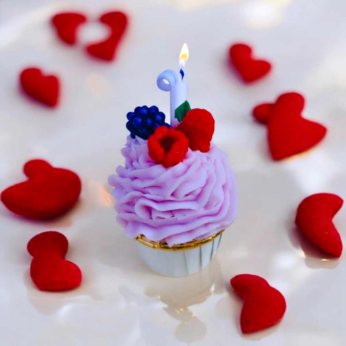 Lavender taro cupcake scented candle with raspberry and blackberry, lit