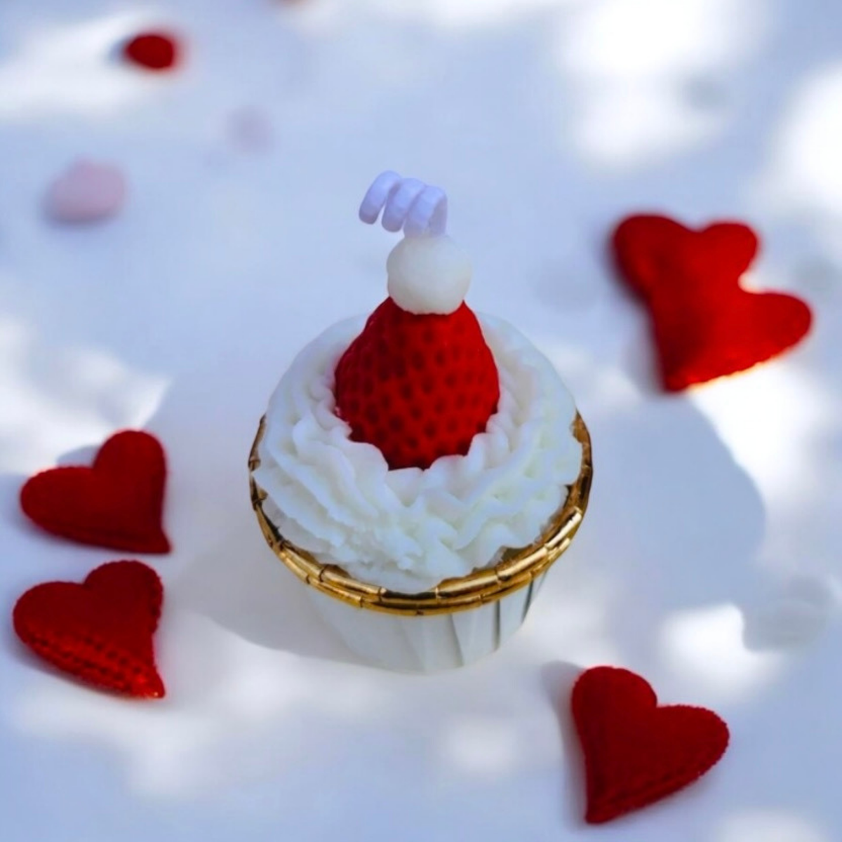 White frosted cupcake scented candle topped with a strawberry