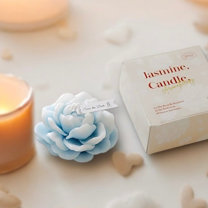 Baby blue peony flower scented candle with gift box and a lit candle behind