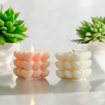 Peach and white heart cube scented candles side by side, one lit