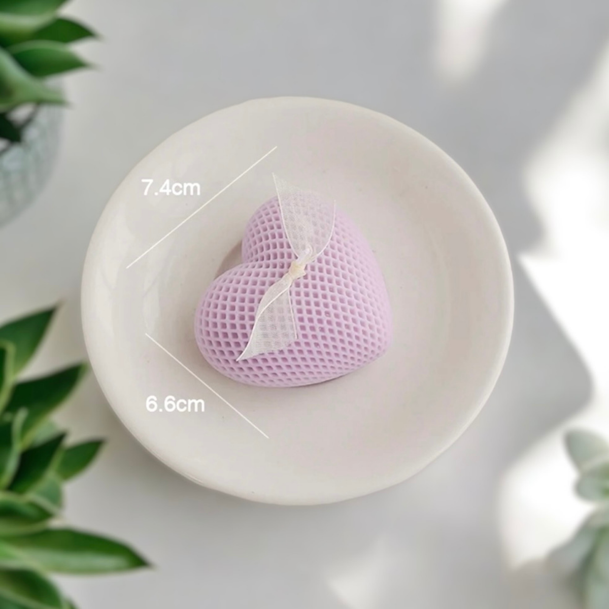 Lilac purple waffle textured heart scented candle on a dish