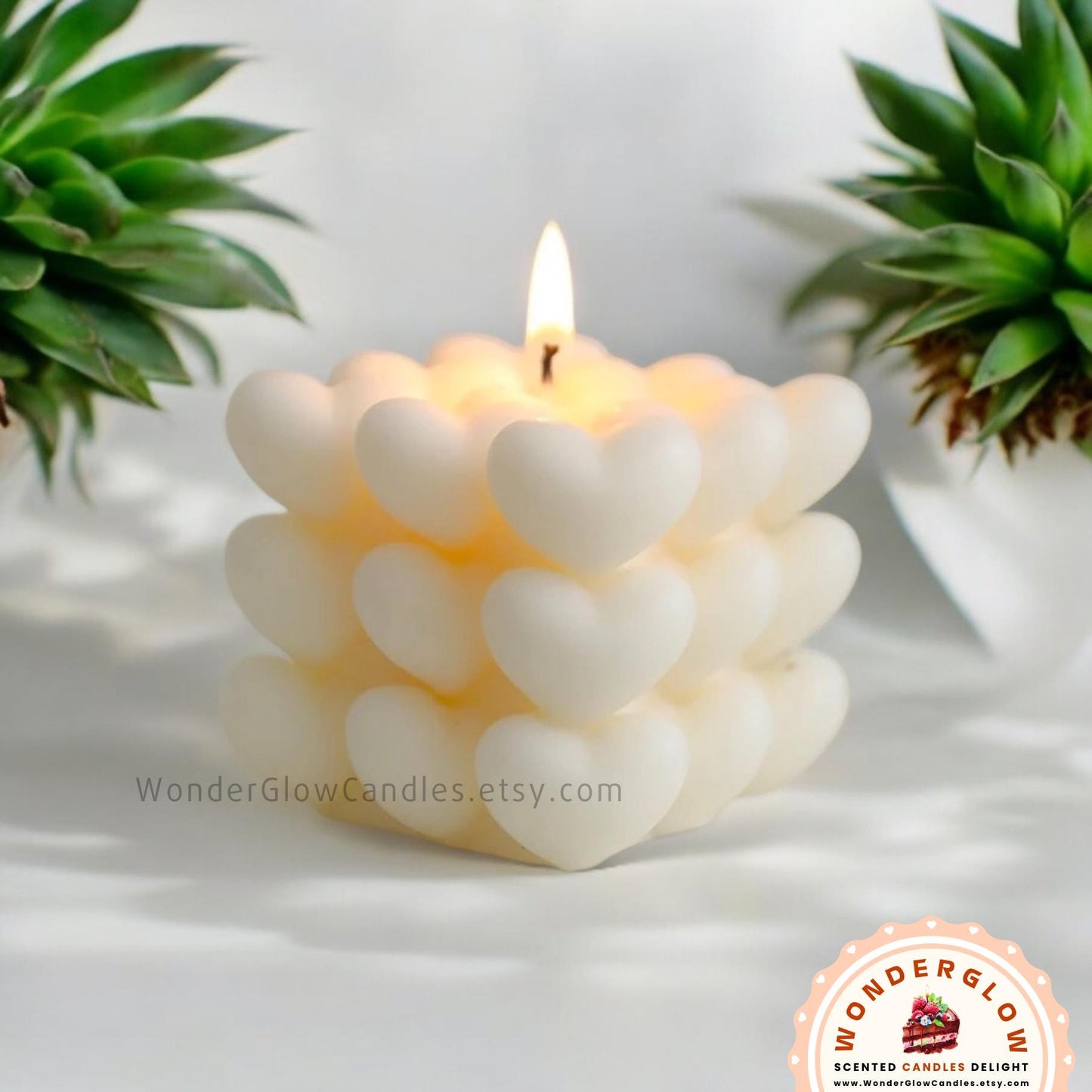 Heart scented candle shown lit