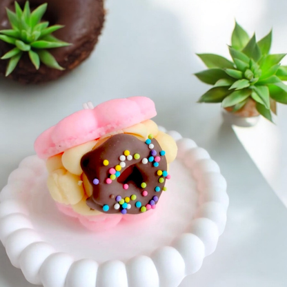 Pink macaron scented candle with a sprinkled chocolate donut filling