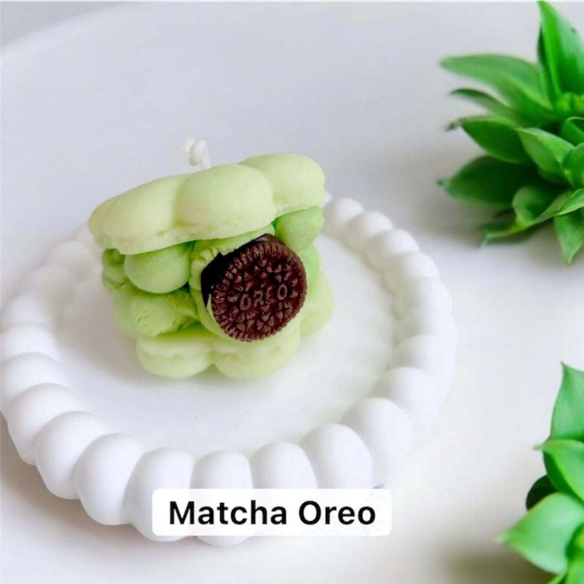 Green matcha macaron scented candle with a chocolate sandwich biscuit filling
