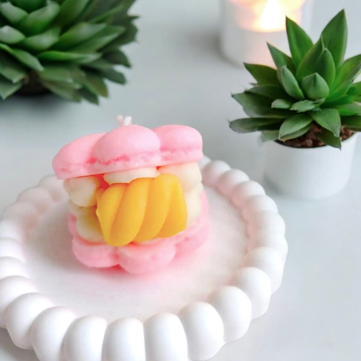 Pink macaron scented candle with yellow mango pineapple filling