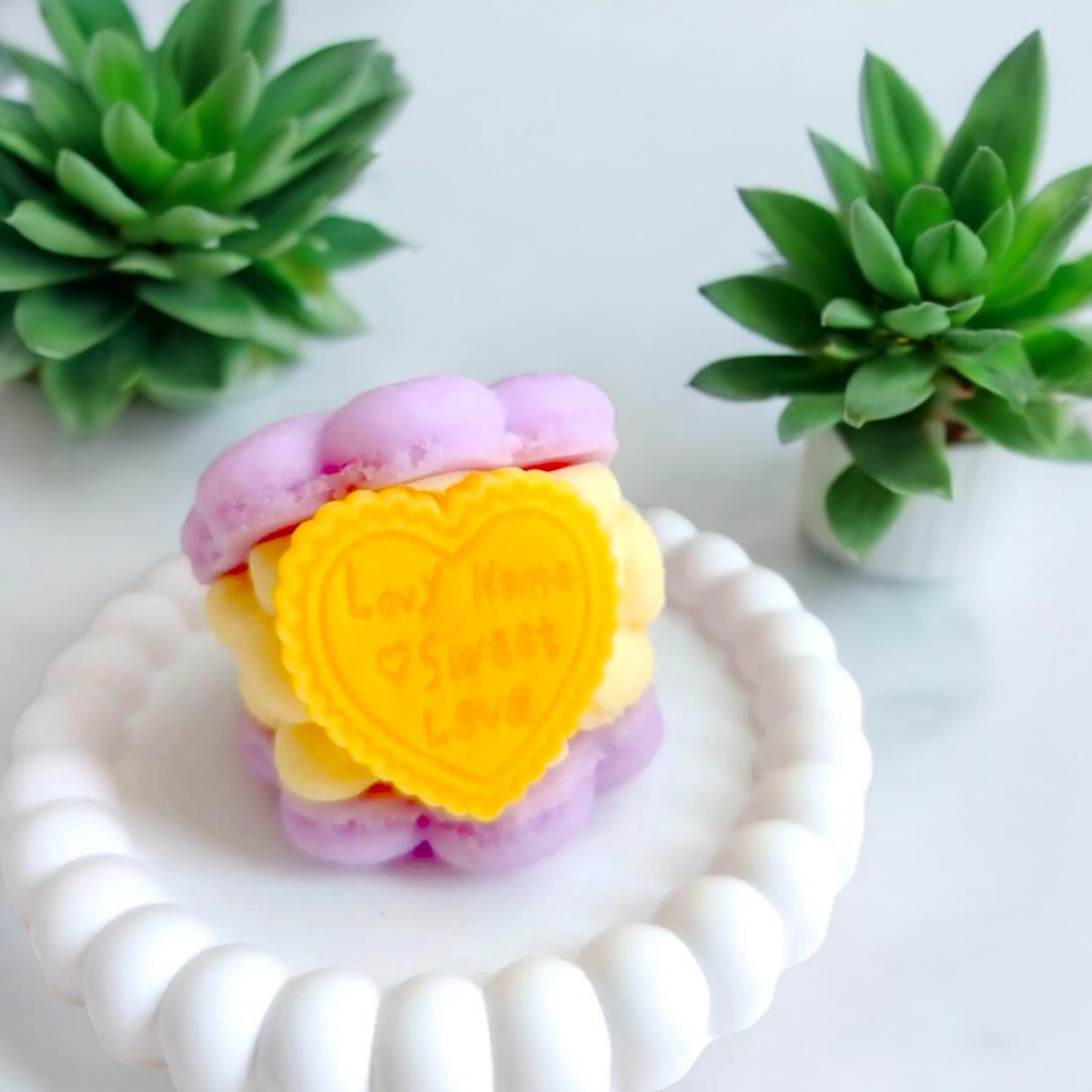 Purple macaron scented candle with a yellow heart filling