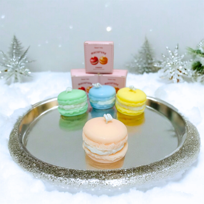 Macaron scented candles on a silver tray in a winter snow setting