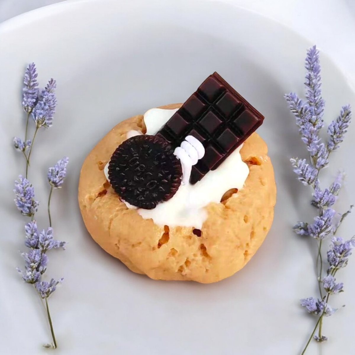 Golden cookie scented candle with a sandwich biscuit and chocolate bar