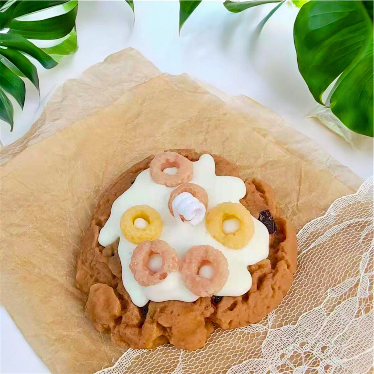 Brown cereal ring cookie scented candle with fruit pieces on top