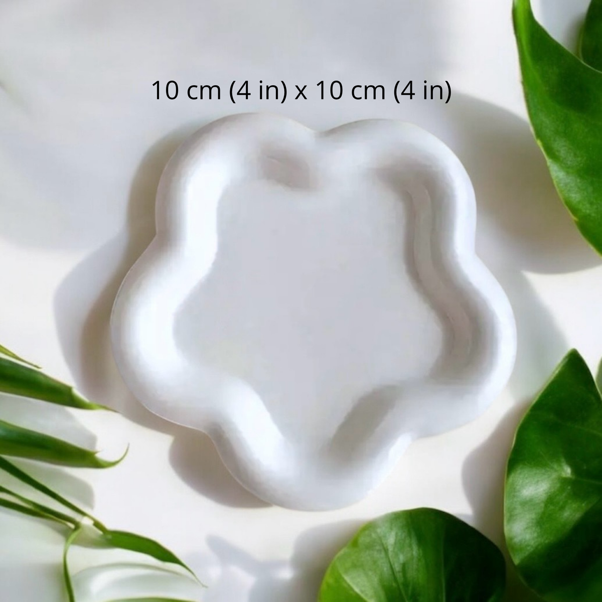 White flower shaped ceramic candle plate, 10 cm by 10 cm