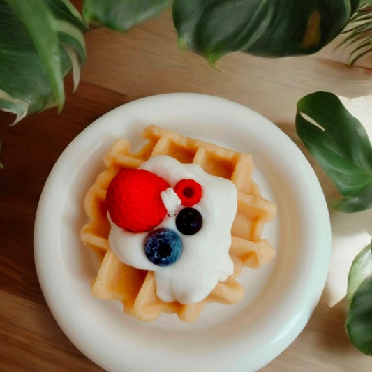 Round waffle scented candle topped with cream, strawberry and blueberries
